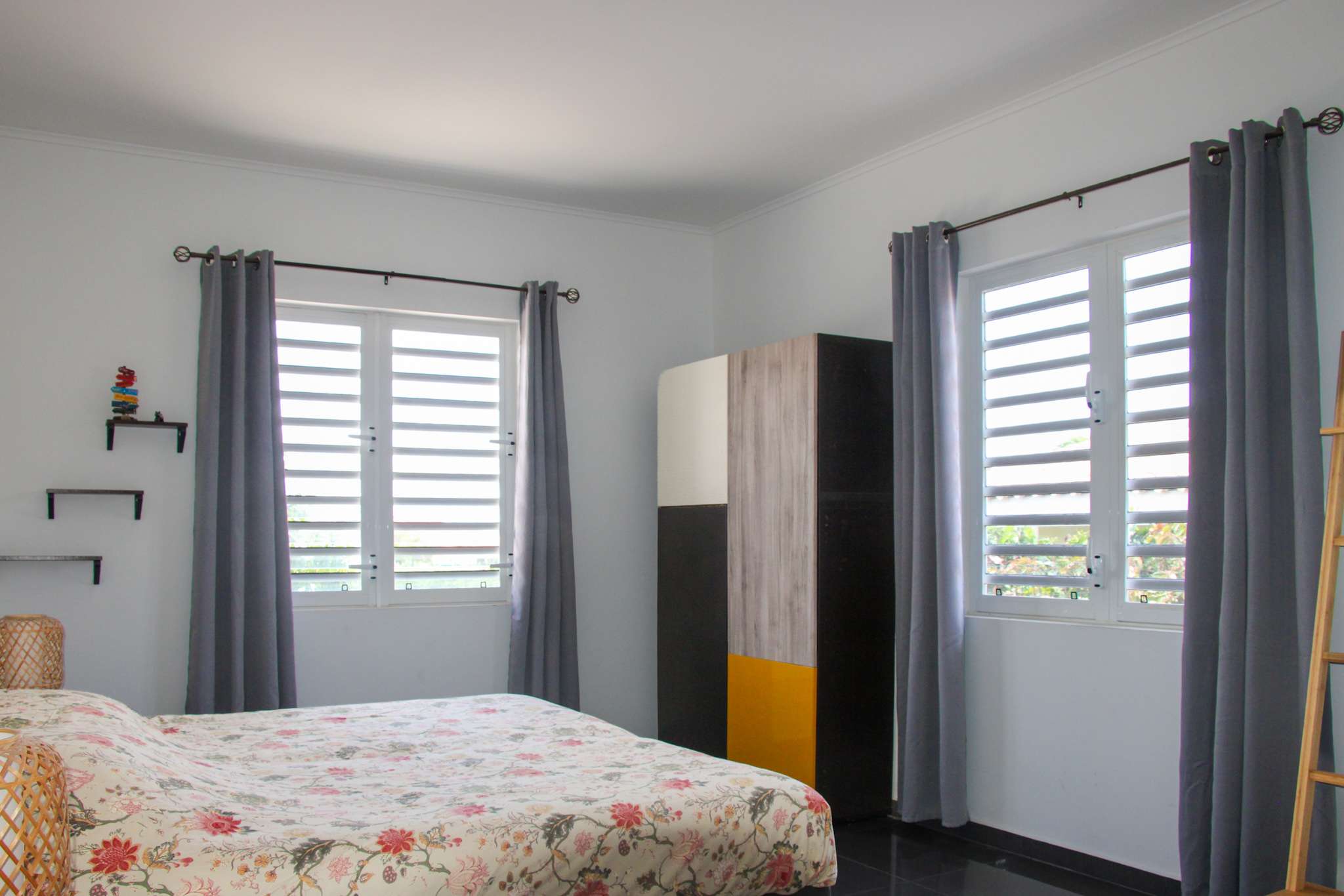 Master bedroom with double bed, wardrobe and two windows