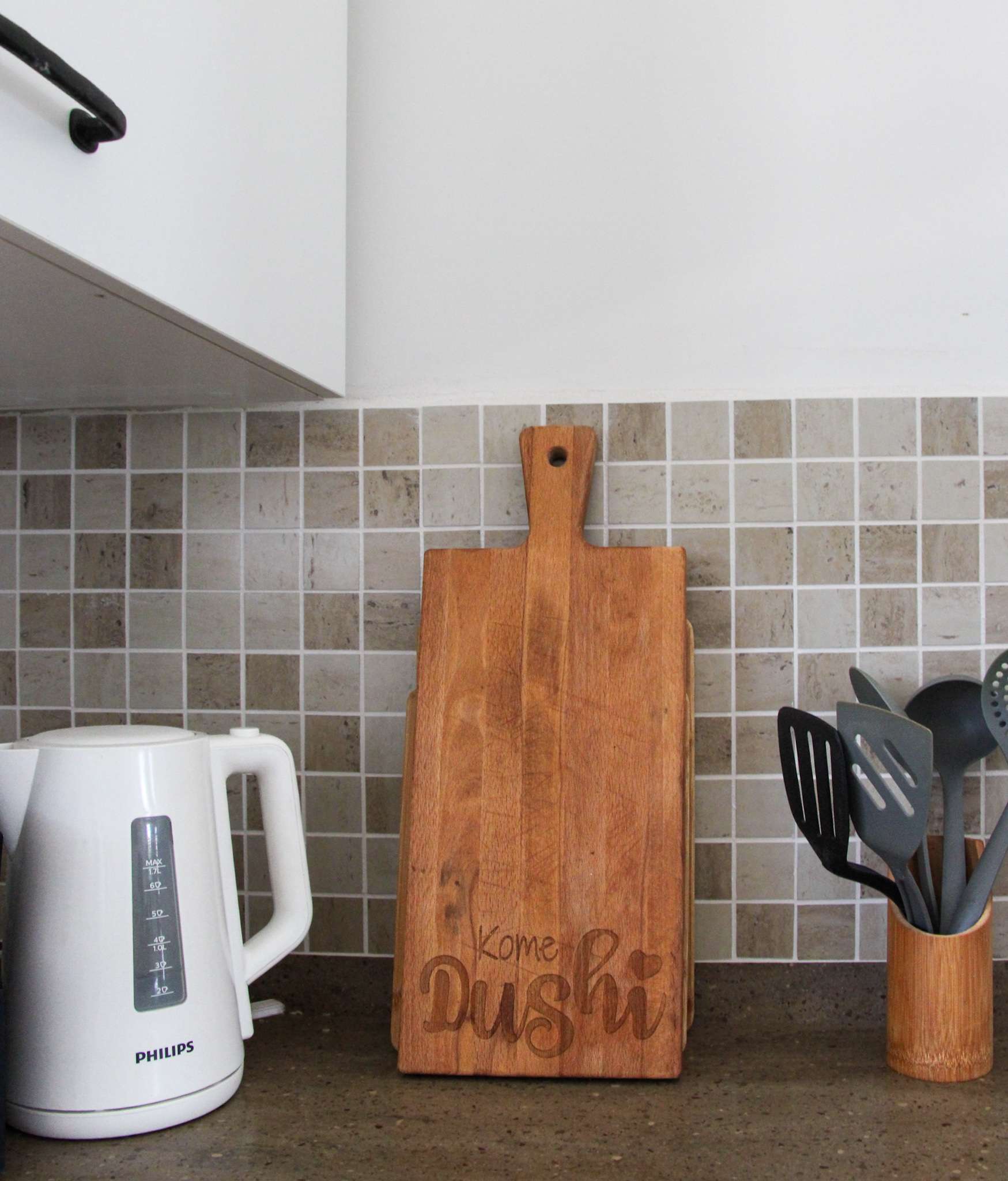 Kome Dushi cutting board and kitchen utensils on the counter
