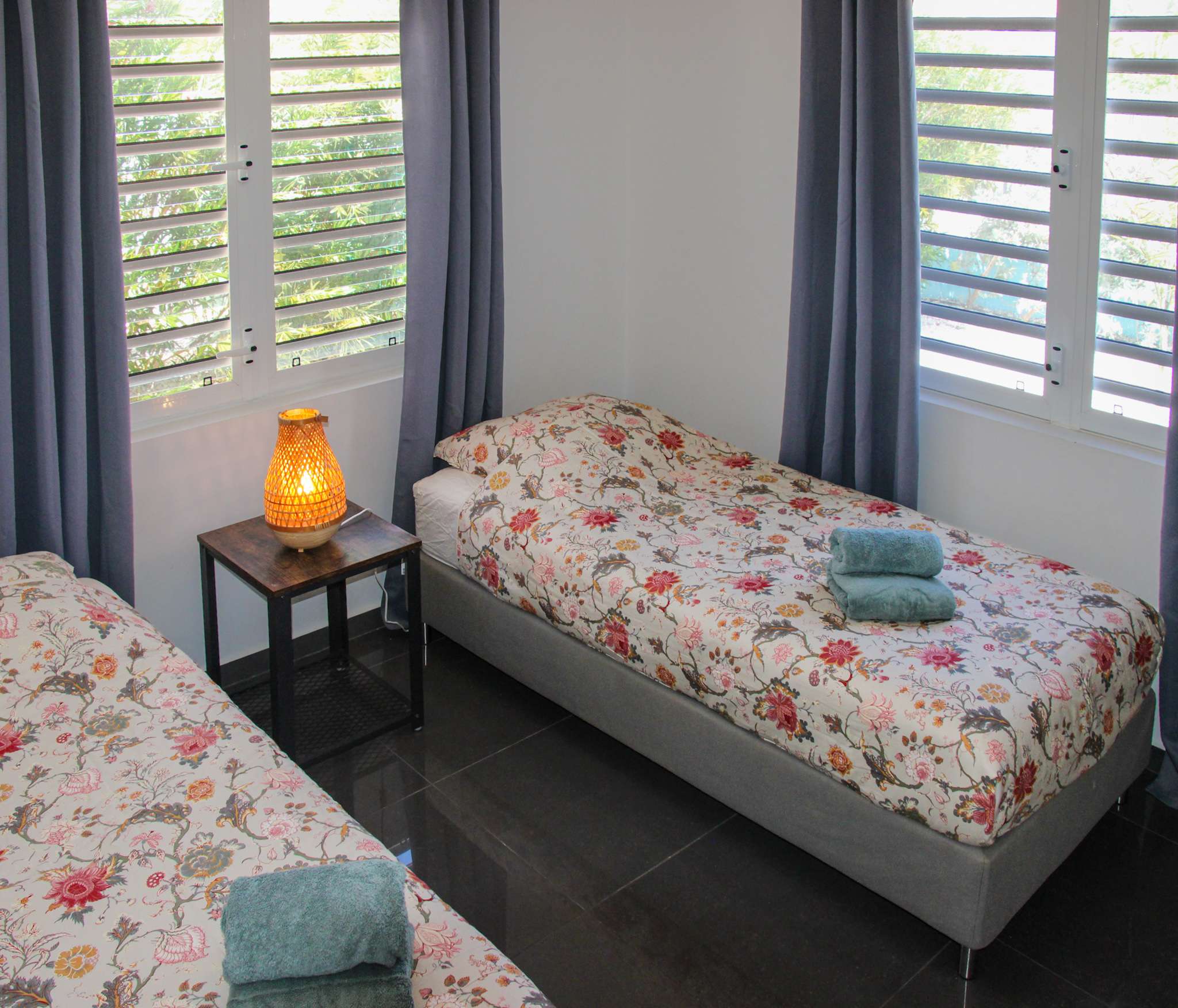 Second bedroom with two single beds by the window